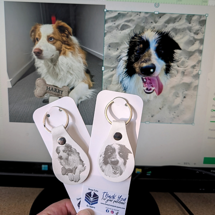 A photo fo 2 dogs on a computer screen with the engraved result on PU leather in front of the screen