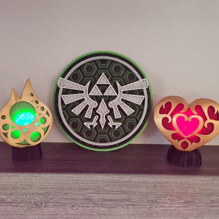Three decorative items with glowing centers on a wooden surface.