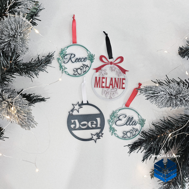 All 4 christmas bauble designs surrounded by christmas tee branges and lights