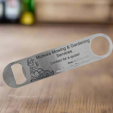 A stainless steel bottle opener engraved with a small illustration, displayed diagonally on a bright blue textured background.