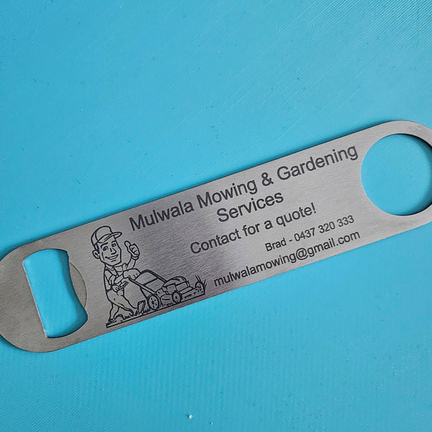 A stainless steel bottle opener engraved with a small illustration, displayed diagonally on a bright blue textured background.
