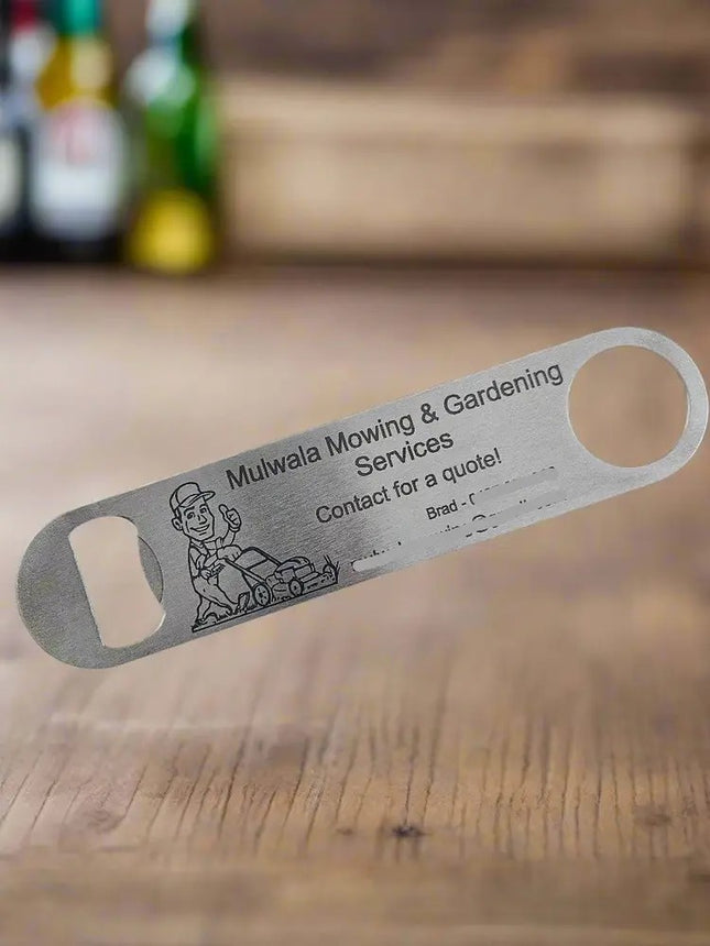 A stainless steel bottle opener engraved with a small illustration, displayed diagonally on a bright blue textured background.