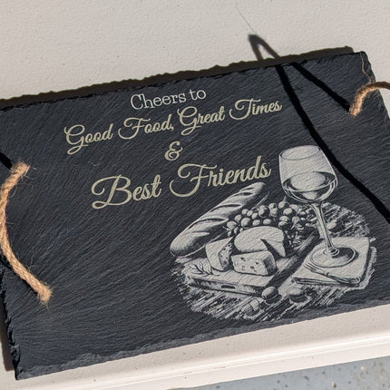 Decorative slate sign with text and a graphic ofcheese bread and wine