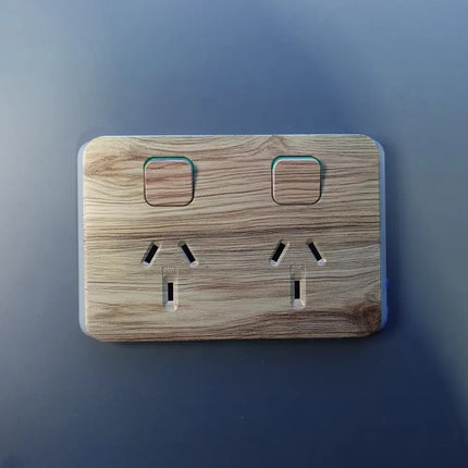 Wooden outlet cover on a blue background