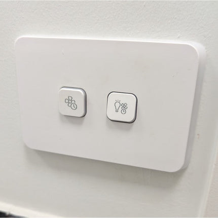 Clipsal iconic two light switch panels with fan and light bulb icons on a white background