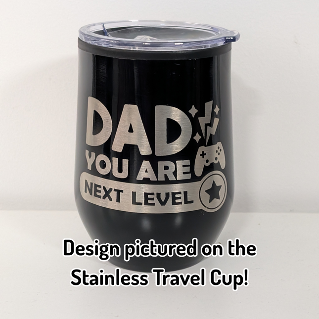 Black stainless travel cup with a design  thats says 'dad you are next level' on a white background