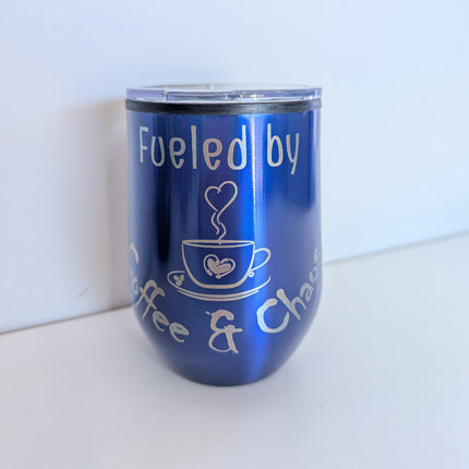 Travel cup in bluw with 'fueled by coffee and chaos engraved onto it