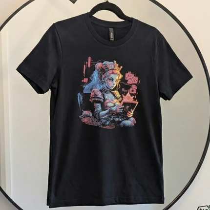 A black short-sleeve crewneck t-shirt hanging on a black hanger against a white wall, featuring a colorful graphic print of a stylized anime character on the front.