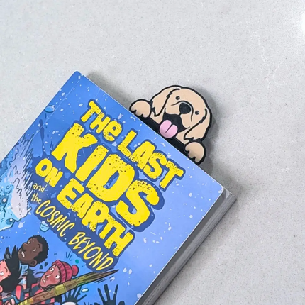 3d printed bookmark with a golden retreiver design shown in a book