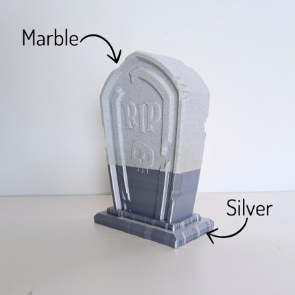 An image of a 3d printed tombstone headphone holder in half silver and half marble