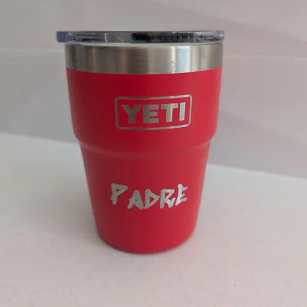 Red YETI tumbler with 'PADRE' text engraved on a white background