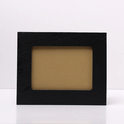A rectangular black Slate picture frame with a textured finish and a tan insert, standing upright on a white surface against a white background.