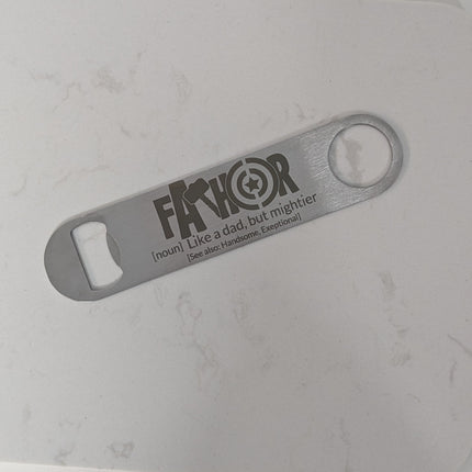 Metal bottle opener with 'FATHOR' spelled out with avenger symbols branding on a gray background