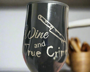 A black 350ml stainless steel travel cup with white text and design, featuring a sword and the phrase 'WINE AND TRUE CRIME'.